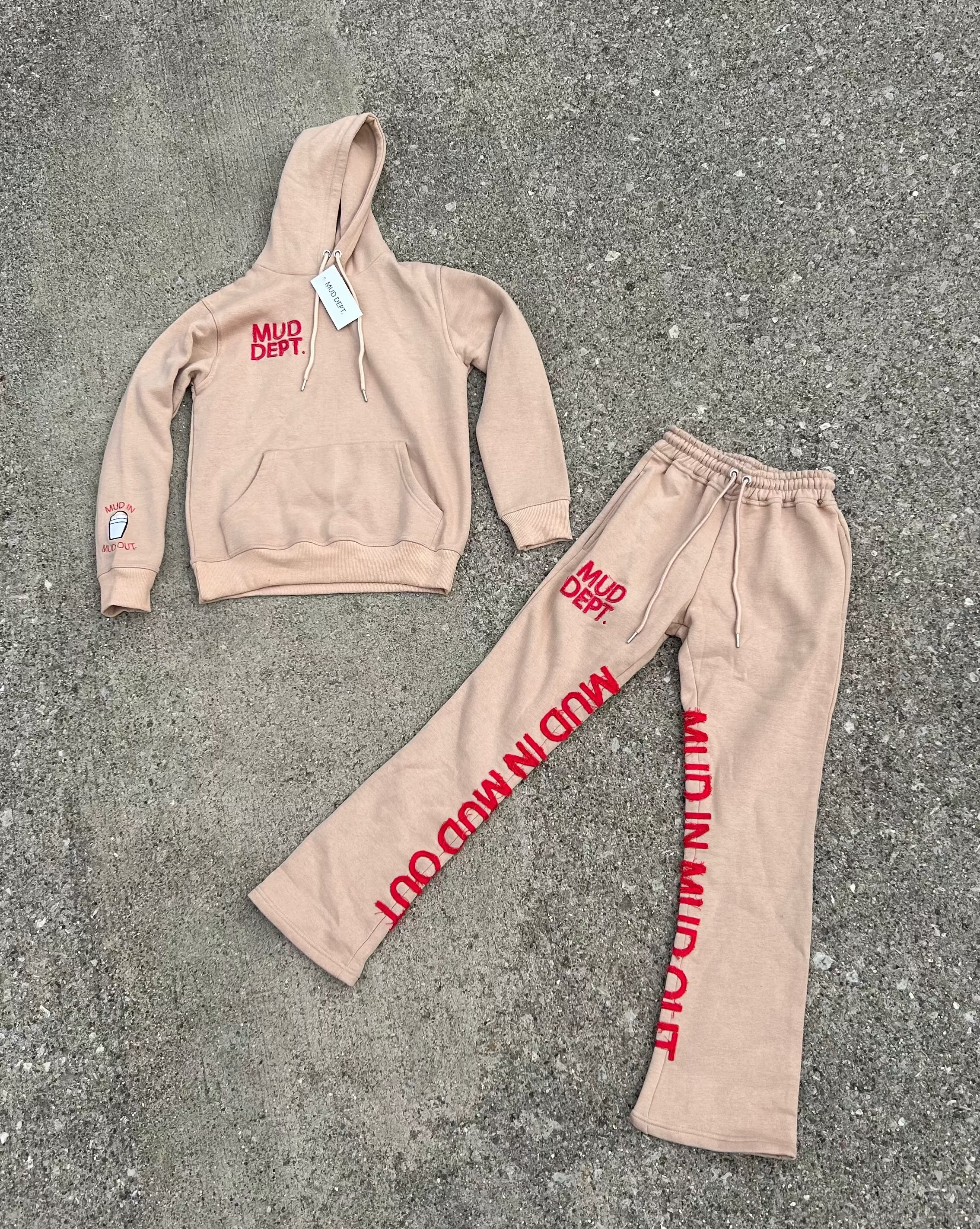 Beige hoodie and pants set with red text 